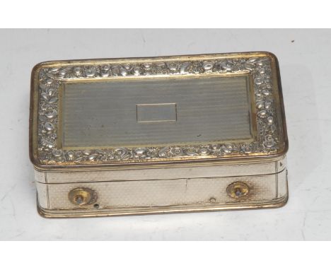 A George III silver rounded rectangular musical table snuff box, engine turned in lateral bands, the hinged cover applied wit