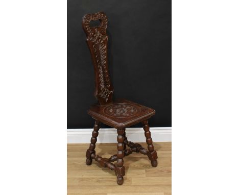 Frank Pratt of Derby - a Victorian style oak spinning chair, shaped back with pierced handle carved in the 17th century taste