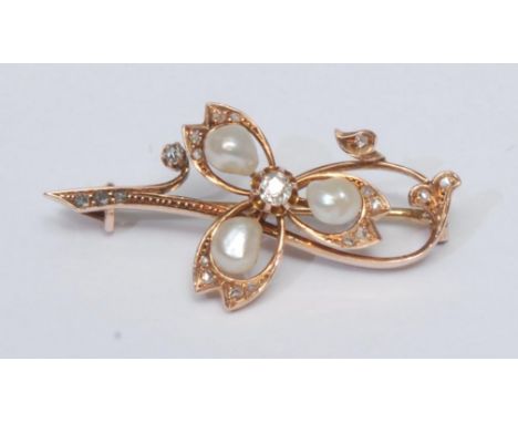 A diamond and pearl brooch, three petal body inset with three irregular creamy white pearls and twenty diamond accents, unmar