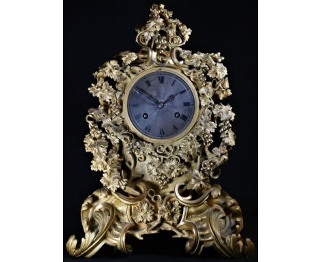 A Louis Philippe ormolu cartouche shaped mantel clock, 10cm silvered dial inscribed with Roman numerals, twin winding holes, 