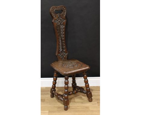 Frank Pratt of Derby - a Victorian style oak spinning chair, shaped back with pierced handle carved in the 17th century taste