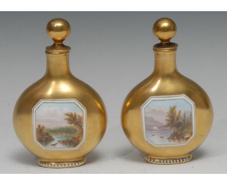 A pair of Coalport pilgrim flask scent bottles, each painted with a canted rectangular landscape vignette on a gilt ground, g