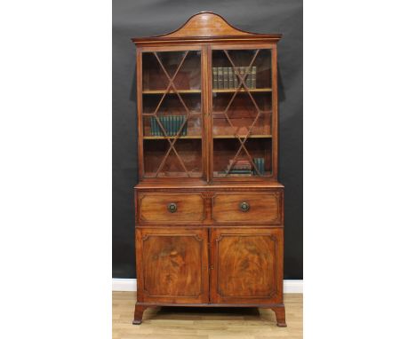 A Regency mahogany library secretaire bookcase, arched cornice above a pair of astragal glazed doors enclosing two adjustable