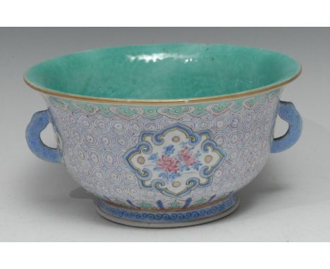 A Chinese flared circular bowl, brightly painted in polychrome with flowers within shaped reserves, on a ground of trellis, w