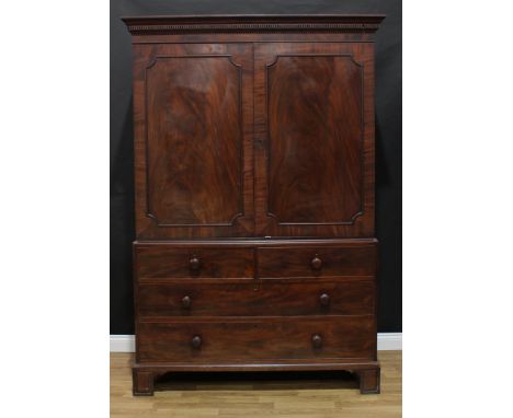 A 19th century flame mahogany 'linen press', dentil cornice above a pair of panel doors enclosing a hanging rail, the base wi