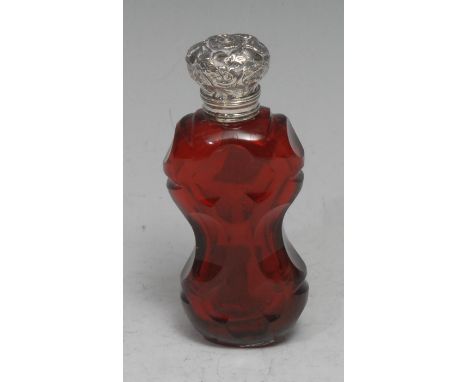 A 19th century silver mounted ruby glass scent bottle, faceted in the Gothic taste, hinged cover chased with scrolling foliag