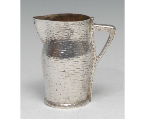 An unusual Victorian silver pitcher cream jug, as a leather jack, gilt interior, 9.5cm high, Edward Hutton, London 1887, 4.25