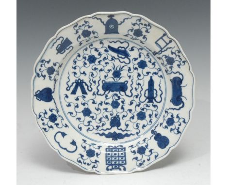 A Worcester Hundreds Antique pattern shaped circular plate, printed in underglaze blue with Chinese archaic precious objects,