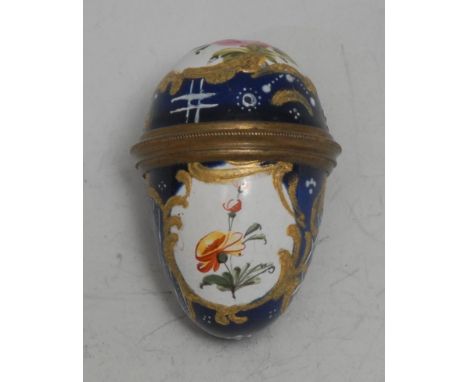 An 18th century South Staffordshire enamel egg shaped bonbonniere, painted with reserves of flowers within gilt leafy cartouc