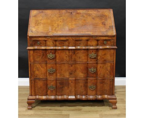 A late 18th century Dutch walnut bureau, fall front with reading ledge enclosing a writing surface, a lockable well with secr