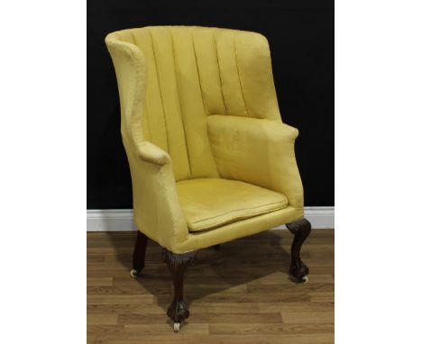 An unusual George II Revival mahogany 'porter's' wingback club armchair, stuffed over upholstery, squab cushion, cabriole leg