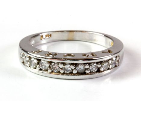 A 14ct white gold diamond set half eternity ring with the word "AMORE" pierced on the shank, (L.5).