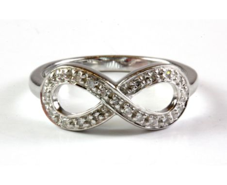 A 9ct white gold diamond set eternity ring, (M).