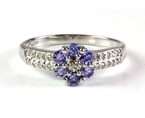 A 9ct white gold tanzanite and diamond set cluster ring, (P.5).