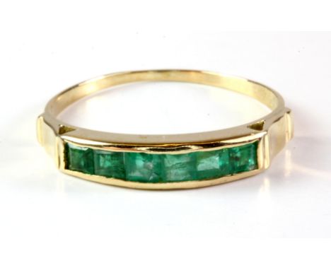 An 18ct yellow gold (stamped 18k) emerald set ring, (Q).