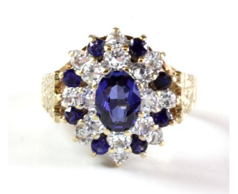 A 9ct yellow gold sapphire and white spinel set cluster ring, (O.5).