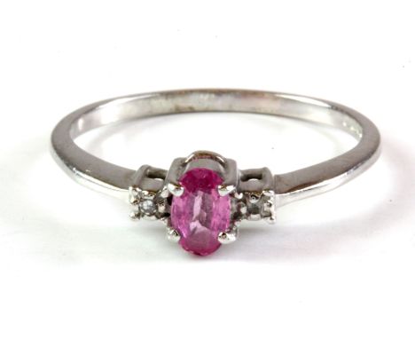 A 9ct white gold pink sapphire set ring with diamond set shoulders, (L.5).