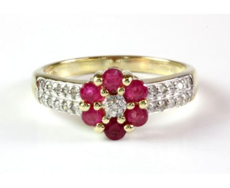 A 9ct yellow gold ruby and diamond set cluster ring with diamond set shoulders, (L.5).