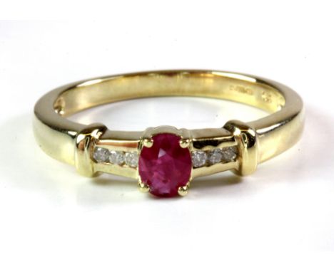 A 9ct yellow gold ruby and diamond set ring, (O).