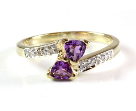 A 9ct yellow gold amethyst and diamond set crossover ring, (N).
