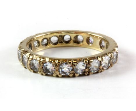 A 9ct yellow gold white spinel set full eternity ring, (O).