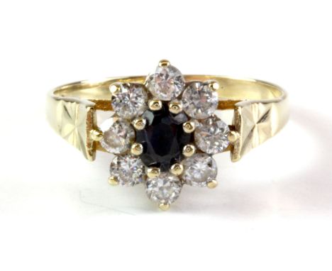 A 9ct yellow gold sapphire and white stone set cluster ring, (L.5).