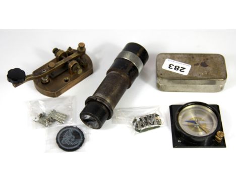 Four military related items, including a Morse tapper and compass.