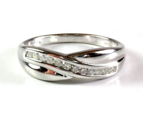 A 9ct white gold diamond crossover ring, (N.5).