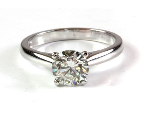 An 18ct white gold solitaire ring set with a 1.10 brilliant cut diamond, (L.5).