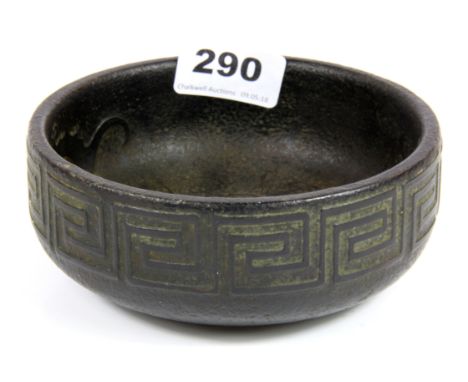 A Chinese carved dark green jade/ hardstone bowl decorated with bats and key pattern, Dia. 13.5cm.