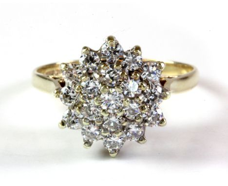 A 9ct yellow gold stone set cluster ring, (M.5).