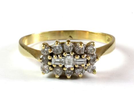 An 18ct yellow gold ring set with brilliant and baguette cut diamonds, (Q.5).