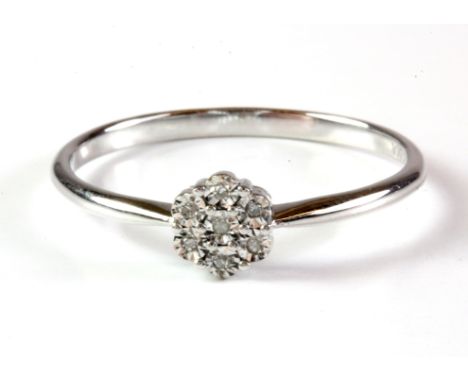 A 9ct white gold diamond set cluster ring, (T).