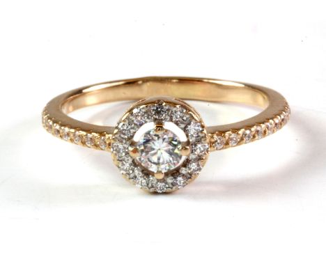 A rose metal (tested high carat rose gold) stone set halo ring, (L.5).