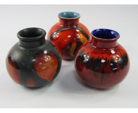 Three Poole Pottery vases, of squat spherical design, 10cm high.