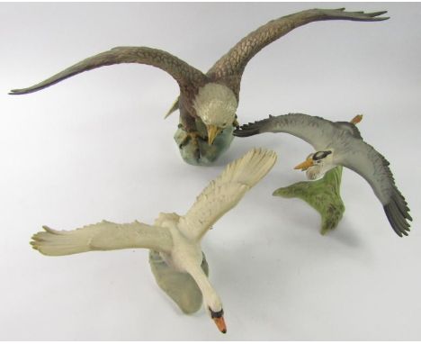 A Goebel model of an White Headed Eagle, with outstretched wings, a Goebel model of a Grey Heron in flight, and a Mute Swan t