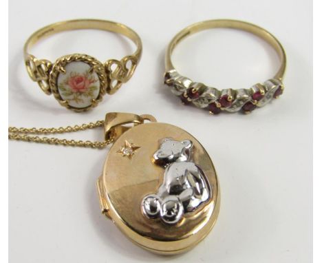 A 9ct gold ruby and diamond dress ring, size 0, 9ct gold and floral porcelain plaque set ring, and a 9ct gold locket on chain