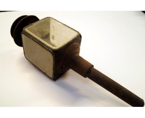 An early 20thC coaching lamp, the shaped square centre section with a three part glazed case with a cylindrical stem surmount