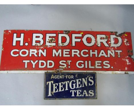 A red enamel advertising sign for H Bedford Corn Merchants, Tydd St Giles, 40.5cm x 122cm, and a blue enamel sign, Agent For 