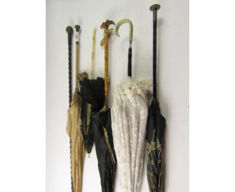 Victorian and later parasols, an ebony and horn topped walking cane and a walking stick, (qty).