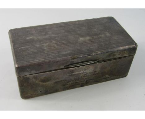 A George V silver cigarette box, of oblong outline, with thumb print handle, hinged to reveal a sectional cedar lined interio
