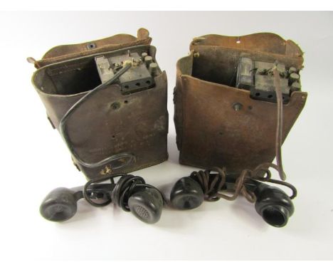 Two military field telephones, leather cased, one marked Signal Corps U.S. Army. Telephone EE-8-A.