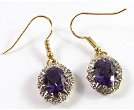 A pair of amethyst and diamond oval cluster drop earrings, set in yellow and white metal, gross weight 3.93g.