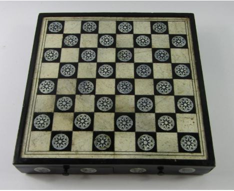 A Chinese soapstone chess set, in an ebony and bone board box with mother of pearl inlay and two frieze drawers, 31cm x 31cm.