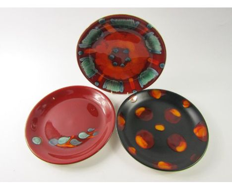 Two Poole Pottery Delphis dishes, 27.5cm diameter, together with a spotted dish, 27.5cm diameter, (3).