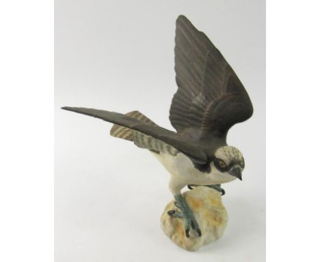 A Spode model of an Osprey, with partially unfurled wings, standing on a rock, 28.5cm high.