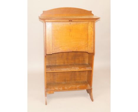 An early 20thC oak bureau, with raised back above a bow fronted shelf, and a fall enclosing a fitted interior, 74cm wide.