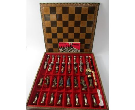 An Italian cast metal chess set modelled as Napoleonic figures, board boxed, with draughts, 38cm x 38cm.