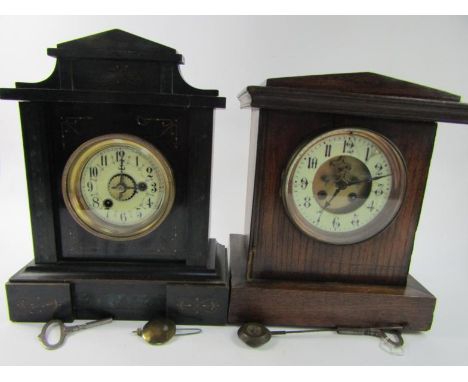 A Victorian oak mantel clock of architectural form, brass dial with enamel chapter ring bearing Arabic numerals, visible broc