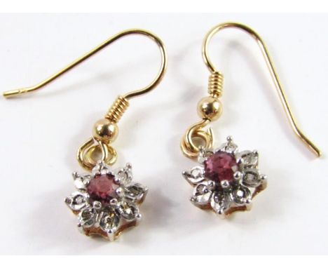 A pair of ruby and diamond flower cluster earrings, set in yellow and white metal with hook fittings, gross weight 1.86g.